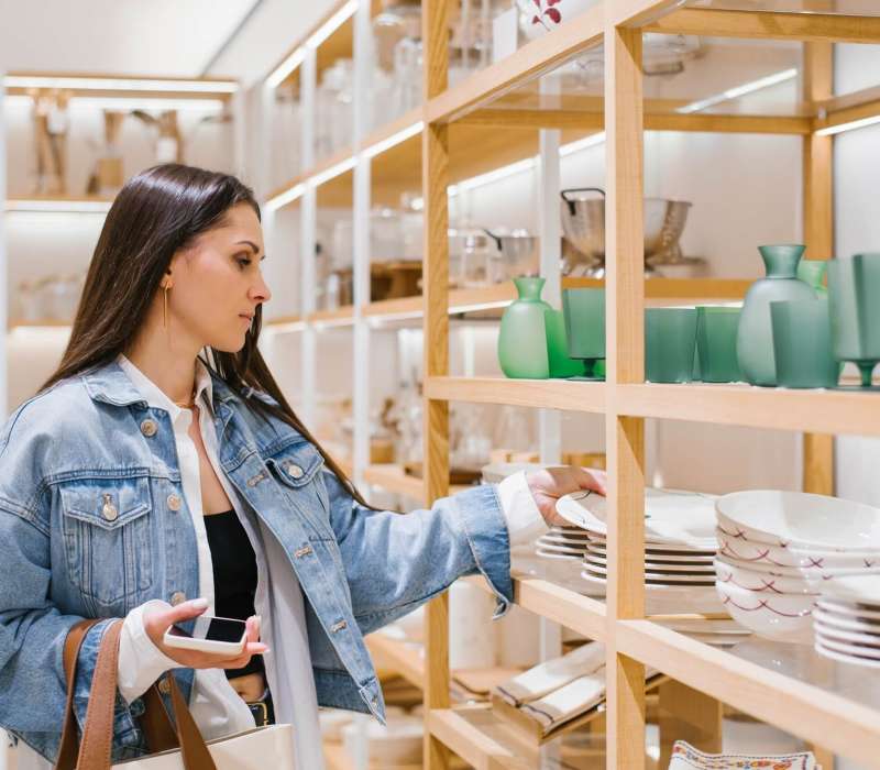young woman chooses crockery in a home improvement shop.jpg young woman chooses crockery in a home improvement shop.jpg
